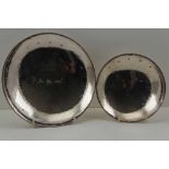 TWO LATE 20TH CENTURY SHALLOW SILVER BOWLS raised on plain ring bases, planished finish, one with