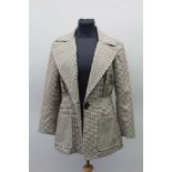 A TRADITIONAL TWEED LADY'S HACKING JACKET, suitable for in-hand showing, supplied by 'Wraggs',