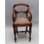 A VICTORIAN MAHOGANY CHILD'S ARMCHAIR, with bowed crest rail and carved single central bar, with