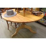 A LATE 20TH CENTURY PINE CIRCULAR TOPPED KITCHEN TABLE on baluster column and three downswept legs
