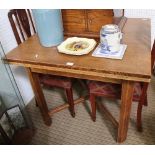 A FIRST QUARTER 20TH CENTURY OAK SQUARE TOPPED DRAWLEAF DINING TABLE supported on four plain