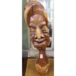 A CARVED WOOD STYLIZED HEAD