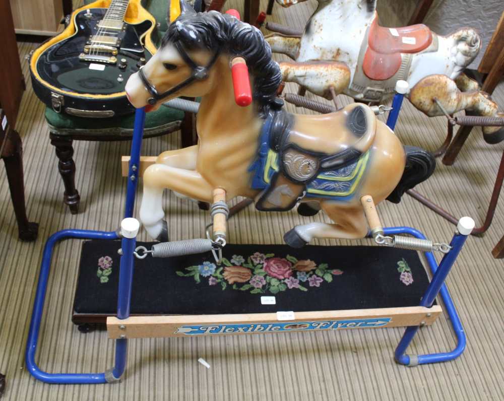 A CHILD'S ROCKING HORSE on metal and wooden frame, titled 'Flexible Flyer'