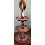 A DELICATE THREE-TIER PORTABLE CAKESTAND on ring formed handle