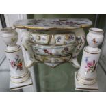 A CONTINENTAL PORCELAIN BOMBE SHAPED TABLE CHEST together with a pair of pedestal candlesticks,
