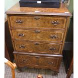 A WELL MADE REPRODUCTION WALNUT COLOURED FOUR DRAWER GRADUATING CHEST, supported on stubby