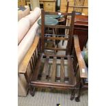 AN EARLY 20TH CENTURY OAK FRAMED MANUALLY RECLINING ARMCHAIR (minus cushions)