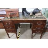 A MID 20TH CENTURY OAK FINISHED TWIN PEDESTAL DESK with skiver insert top, and two banks of three