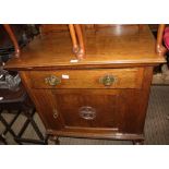 A PROBABLE CONTINENTAL OAK SIDE UNIT having plain top over single drawer and decorative panelled