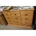 A LATE 20TH CENTURY PINE DOUBLE WIDTH CHEST OF NINE DRAWERS, on a plain plinth base