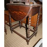 AN OAK FINISHED SMALL SIZED TWIN FLAP TABLE with barley twist legs