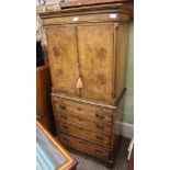 A GOOD QUALITY REPRODUCTION WALNUT COLOURED CABINET ON CHEST, the upper section having twin cupboard