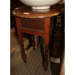 AN OAK FINISHED CIRCULAR TOPPED OCCASIONAL TABLE with deep frieze and barley twist and block legs