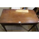 AN EARLY 20TH CENTURY MAHOGANY FOLD-OVER TEA TABLE, having fitted central storage drawer