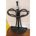 A BLACK PAINTED METAL DEMI-LUNE STICK STAND