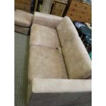 AN AFRICAN LEATHER UPHOLSTERED THREE PERSON SETEE, with matching footstool