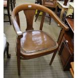 A FIRST QUARTER 20TH CENTURY HORSESHOE BACKED ARMCHAIR with rexine and stud work seat pad