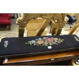 A LONG AND LOW FLORAL WOOLWORK PAD TOPPED FOOTSTOOL on scrolling knuckle feet