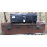 A BLACK FINISHED STORAGE TIN TRUNK together with a brown leather suitcase