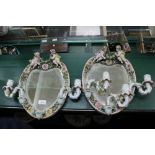 A PAIR OF PROBABLE CONTINENTAL FLORAL ENCRUSTED HANGING HEART SHAPED MIRRORED BACK SCONCES