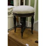 A LATE 19TH CENTURY CIRCULAR PAD TOPPED PIANO STOOL on multi ring turned leg support