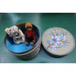 AN ORIENTAL FLORAL CLOISONNE CIRCULAR LIDDED POT, containing a felt covered cast metal monkey and an