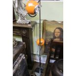 A RETRO DESIGNED FREESTANDING LAMP with chromed fittings and twin spherical orange eye ball lamp