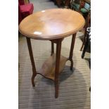 AN OAK FINISHED OVAL TOPPED OCCASIONAL TABLE on four shaped legs, with a planked undertier