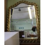 A SHIELD SHAPED FANCY PIERCED GILT FRAMED BEVELLED PLATE WALL MIRROR