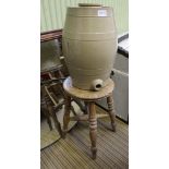 A CIRCULAR TOPPED FOUR LEGGED STOOL together with a kitchen crock