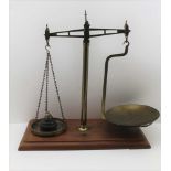 A SET OF 'VANDOME, TITFORD & CO. LTD' LONDON BRASS BALANCE SCALES, on mahogany base board, with