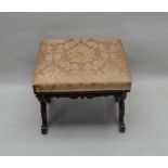 A 19TH CENTURY MAHOGANY SQUARE PAD TOPPED STOOL on twin carved 'X' shaped sides, united by a