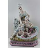 A CONTINENTAL PORCELAIN FIGURE GROUP, a young woman in classical dress with two cherubs in a
