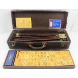 A MID 20TH CENTURY MAH-JONG GAME, with tiles, and rule / guide book, possibly American, the case