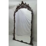 A 19TH CENTURY CARVED WOOD ROCOCO DESIGN FLORAL MIRROR FRAME, housing a plain plate, 213cm high x