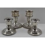 A PAIR OF EDWARDIAN SILVER CANDLESTICKS, with circular platform bases, Chester 1908, 7.5cm high,