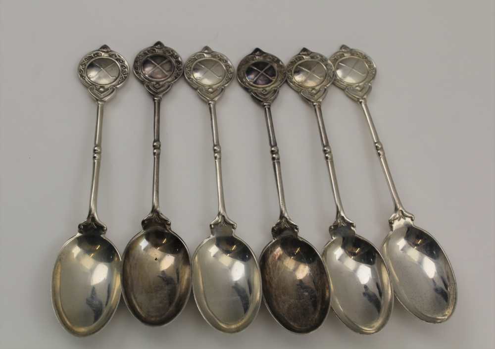 COOPER BROTHERS & SONS A MATCHED SET OF SIX SILVER GOLF TROPHY TEASPOONS, the terminals with crossed