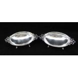 WILSON SHARP A PAIR OF VICTORIAN DESIGN SILVER BONBON DISHES of oval form with bow handles on four