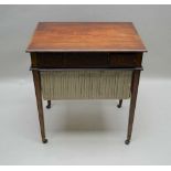 AN EARLY 19TH CENTURY MIXED WOOD WORK TABLE, having a rectangular rosewood top, over three inline