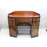A 19TH CENTURY MAHOGANY BOW FRONT BUFFET SIDEBOARD, with gallery top, fitted five drawers and a