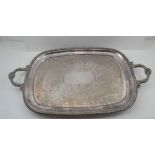 A HEAVY EPNS TWO HANDLED OVAL DRINKS TRAY, having cast applied gadroon rim, foliate handles & scroll