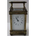 A 19TH CENTURY BRASS FRAMED CARRIAGE CLOCK white enamel dial with Roman numerals, bevel plate