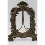 A FRENCH CAST BRONZE PHOTOGRAPH OR MIRROR FRAME, floral and cherub decoration, with easel stand, c.