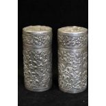 A PAIR OF CHINESE SILVER PEPPER POTS, of cylindrical form, blossom decorated in the round, with