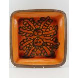 MARGERY CLINTON A STUDIO POTTERY TERRACOTTA DISH, glazed in volcanic orange with applied