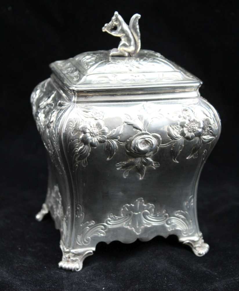 PIERRE GILLIOS AN EARLY GEORGE III SILVER TEA CANNISTER/CADDY of rectangular bombe form, repousse