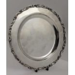 A STERLING SILVER SALVER / WAITER with cast decorative rim, 21cm in diameter, weight; 342g