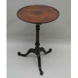 A LATE 19TH CENTURY MAHOGANY FINISHED SAUCER TOPPED TABLE, having carved rope work edge, supported