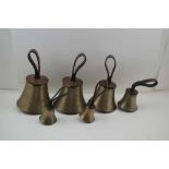 A SET OF SIX HAND BELLS, with butler straps, the leather caps embossed 'GW', (Probably for the