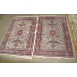 A PAIR OF PERSIAN DESIGN WOVEN WOOL FLOOR RUGS, having star shaped central motif, on a busy floral